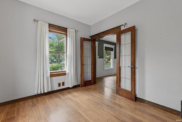 1060 Woodward Ave, South Bend, IN 46616 - unfurnished room with french doors, light wood-style flooring, and plenty of natural light