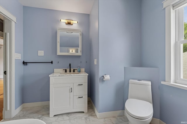 1060 Woodward Ave, South Bend, IN 46616 - bathroom with marble finish floors, vanity, and a tub