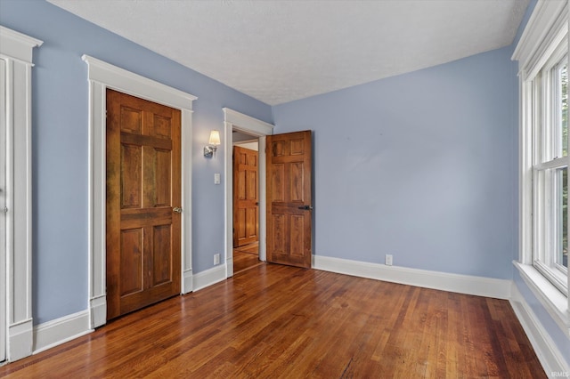 1060 Woodward Ave, South Bend, IN 46616 - unfurnished bedroom with wood finished floors and baseboards