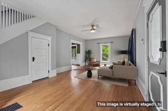 1060 Woodward Ave, South Bend, IN 46616 - living room with light wood-style floors and a ceiling fan