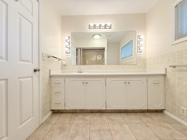 806 N Tippy Dr, Marion, IN 46952 - full bathroom featuring tile walls, tile patterned floors, vanity, and wainscoting