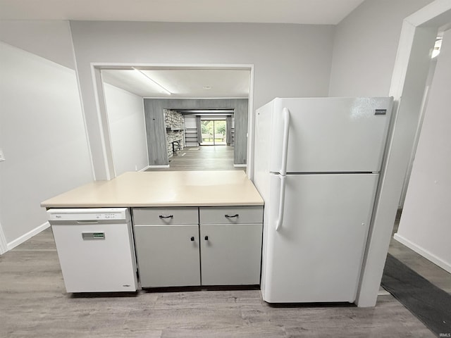 806 N Tippy Dr, Marion, IN 46952 - kitchen featuring white appliances, light countertops, and light wood-type flooring