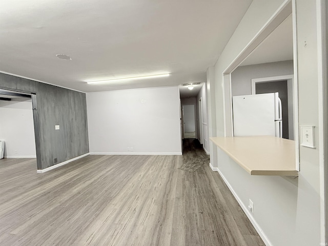 806 N Tippy Dr, Marion, IN 46952 - below grade area featuring freestanding refrigerator and wood finished floors