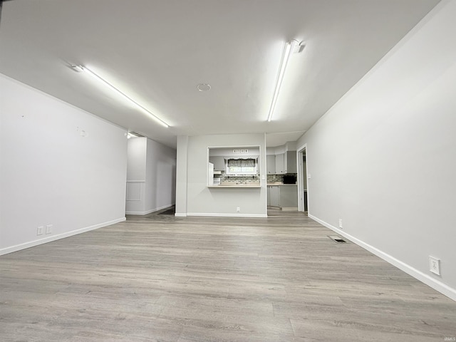 806 N Tippy Dr, Marion, IN 46952 - unfurnished living room featuring wood finished floors and baseboards
