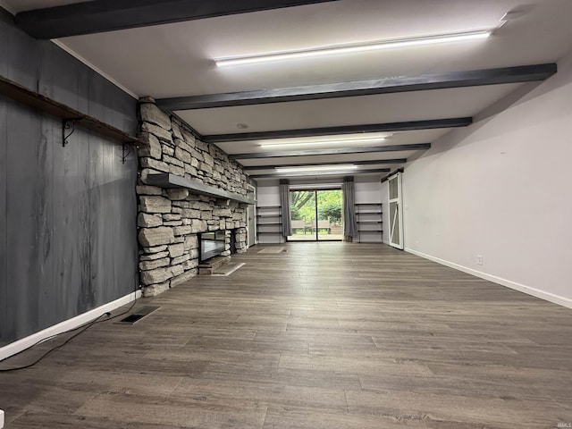806 N Tippy Dr, Marion, IN 46952 - unfurnished living room featuring beam ceiling, a fireplace, and wood finished floors