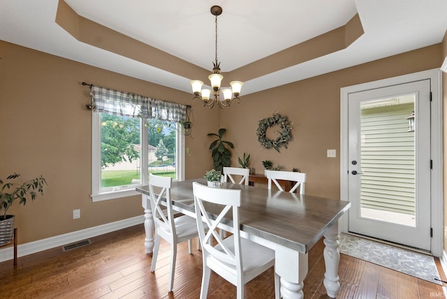 1176 W Whitetail Dr, Columbia City, IN 46725 - dining area featuring a chandelier, hardwood / wood-style flooring, and a raised ceiling