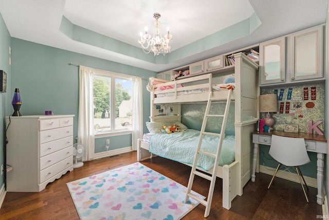 1176 W Whitetail Dr, Columbia City, IN 46725 - bedroom featuring a chandelier, a tray ceiling, and wood finished floors