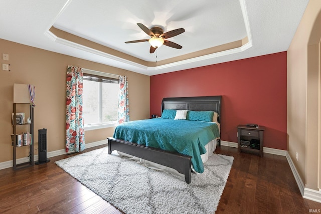 1176 W Whitetail Dr, Columbia City, IN 46725 - bedroom featuring a raised ceiling, hardwood / wood-style flooring, and a ceiling fan