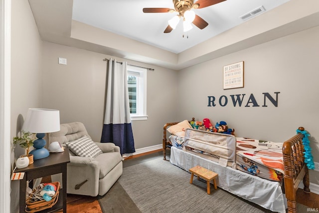 1176 W Whitetail Dr, Columbia City, IN 46725 - bedroom with wood finished floors, ceiling fan, and a raised ceiling