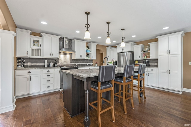 1176 W Whitetail Dr, Columbia City, IN 46725 - kitchen with open shelves, wall chimney range hood, appliances with stainless steel finishes, dark wood-type flooring, and decorative backsplash