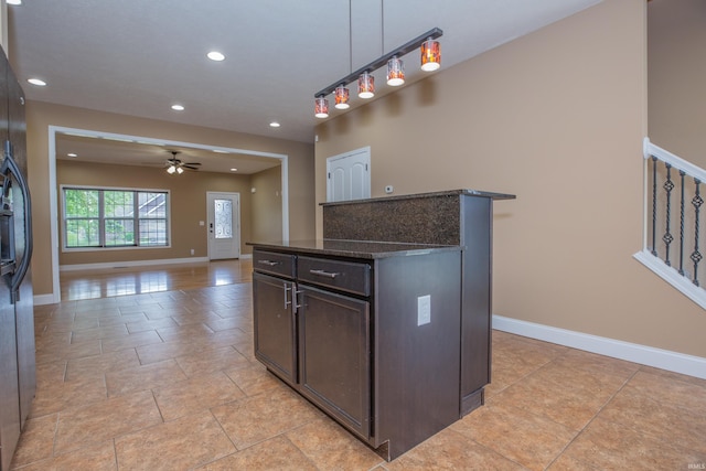 15442 Aj Dr, Evansville, IN 47725 - kitchen with a ceiling fan, dark brown cabinetry, decorative light fixtures, recessed lighting, and dark stone counters