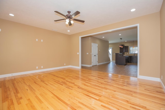 15442 Aj Dr, Evansville, IN 47725 - unfurnished living room with light wood-style floors, a ceiling fan, and recessed lighting