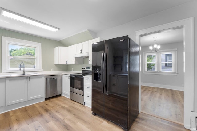 2318 Dodge Ave, Fort Wayne, IN 46805 - kitchen with stainless steel appliances, white cabinets, light countertops, light wood-style flooring, and under cabinet range hood