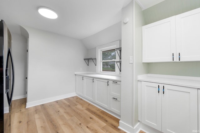 2318 Dodge Ave, Fort Wayne, IN 46805 - bar area featuring refrigerator with ice dispenser, light wood finished floors, and vaulted ceiling