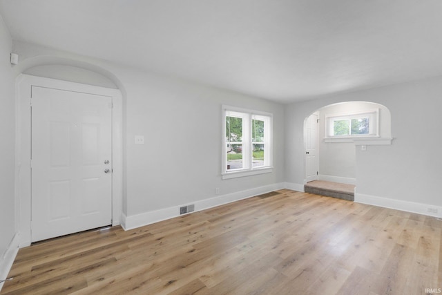 2318 Dodge Ave, Fort Wayne, IN 46805 - unfurnished living room with arched walkways and light wood-style floors