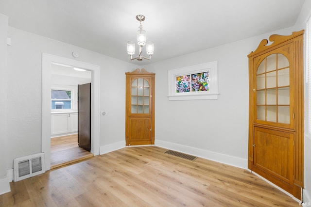 2318 Dodge Ave, Fort Wayne, IN 46805 - unfurnished dining area featuring light wood finished floors and a chandelier