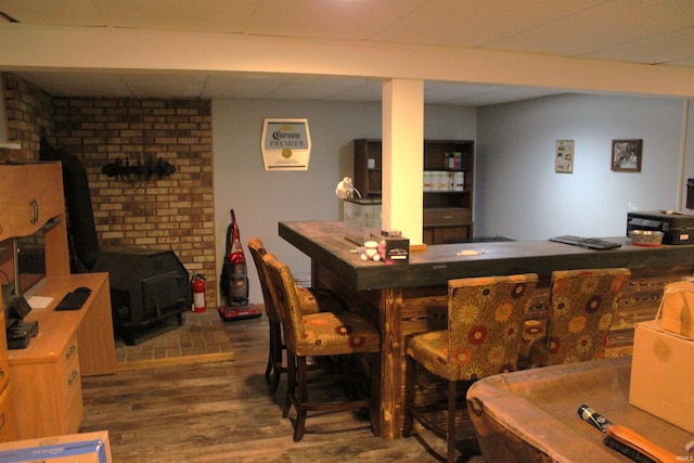 50859 Oak Tree Ln, Bristol, IN 46507 - indoor dry bar featuring a wood stove, wood finished floors, and a paneled ceiling
