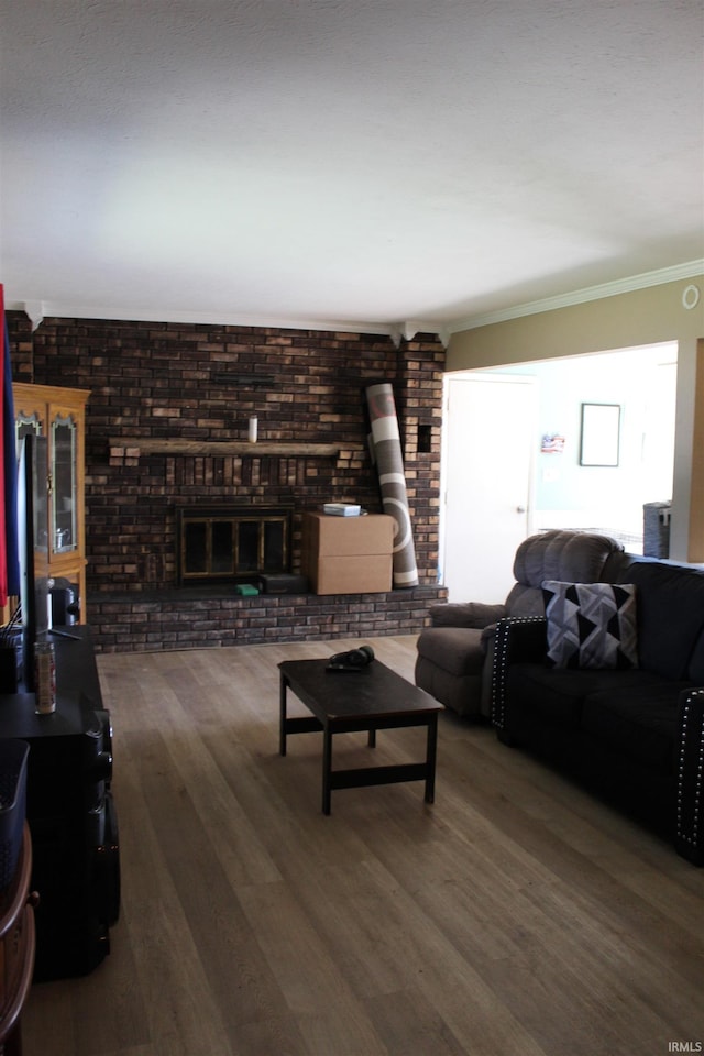 50859 Oak Tree Ln, Bristol, IN 46507 - living area with crown molding, wood finished floors, brick wall, and a fireplace