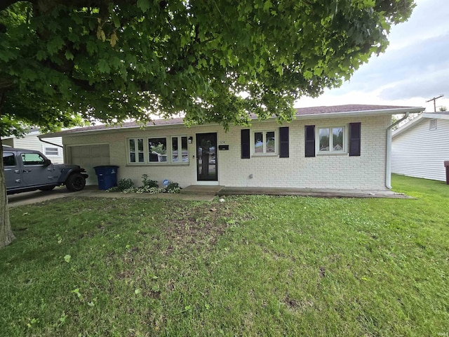 614 N Lancelot Dr, Marion, IN 46952 - single story home featuring a garage, brick siding, and a front lawn