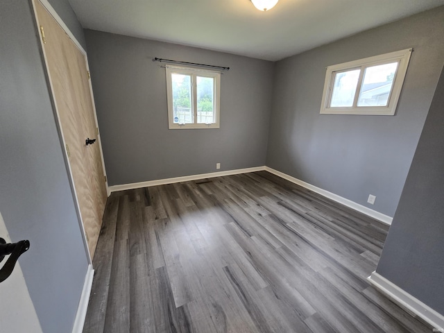 614 N Lancelot Dr, Marion, IN 46952 - unfurnished bedroom with dark wood finished floors and baseboards