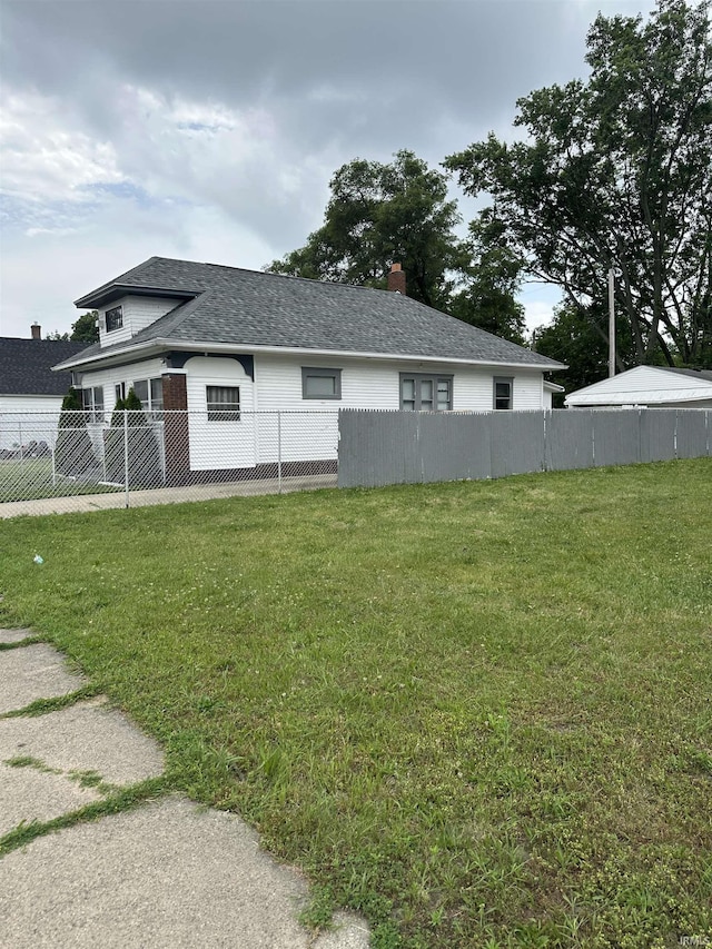 731 Johnson St, South Bend, IN 46628 - view of side of property with a shingled roof
