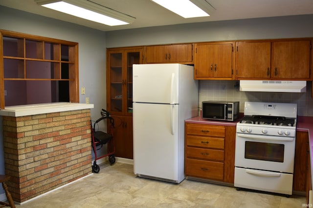 2726 S Roena St, Indianapolis, IN 46241 - kitchen with white appliances, under cabinet range hood, brown cabinetry, and decorative backsplash