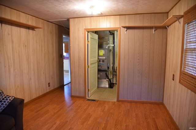 2726 S Roena St, Indianapolis, IN 46241 - spare room featuring wooden walls, wood finished floors, and heating unit
