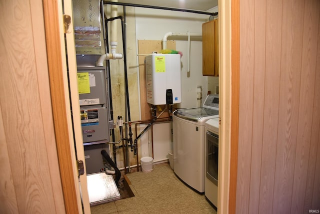 2726 S Roena St, Indianapolis, IN 46241 - washroom featuring water heater, separate washer and dryer, and cabinet space