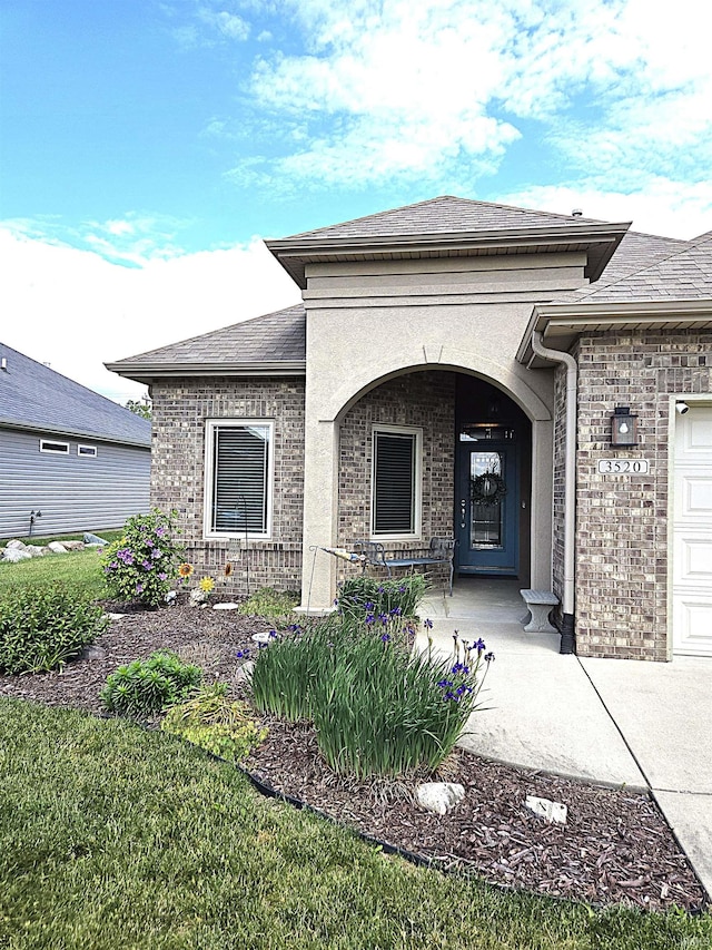 3520 Lintel Dr, West Lafayette, IN 47906 - view of exterior entry featuring brick siding, a shingled roof, and covered porch