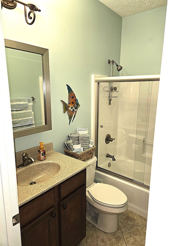 3520 Lintel Dr, West Lafayette, IN 47906 - full bathroom featuring vanity, shower / bath combination with glass door, tile patterned flooring, and a textured ceiling