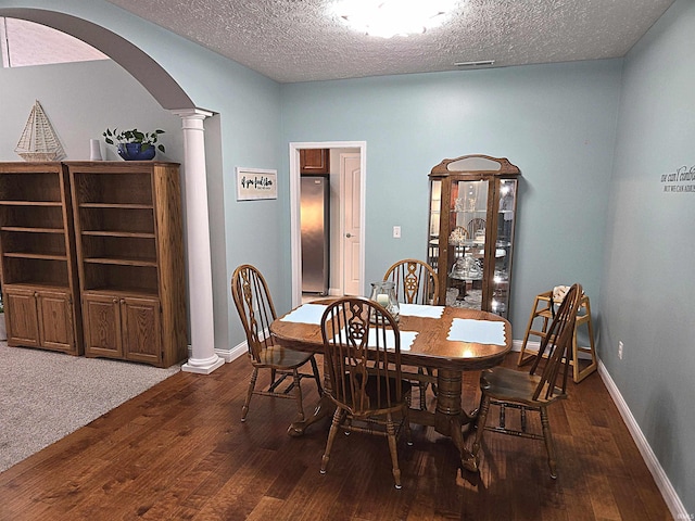 3520 Lintel Dr, West Lafayette, IN 47906 - dining area featuring ornate columns, arched walkways, hardwood / wood-style flooring, and a textured ceiling