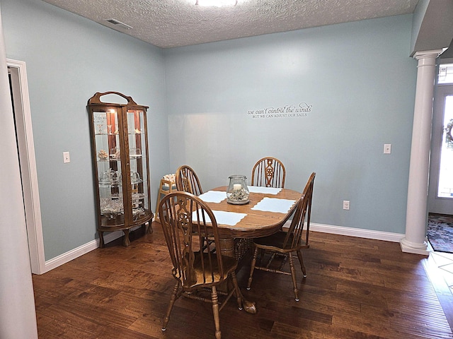 3520 Lintel Dr, West Lafayette, IN 47906 - dining space featuring decorative columns, dark wood finished floors, and a textured ceiling