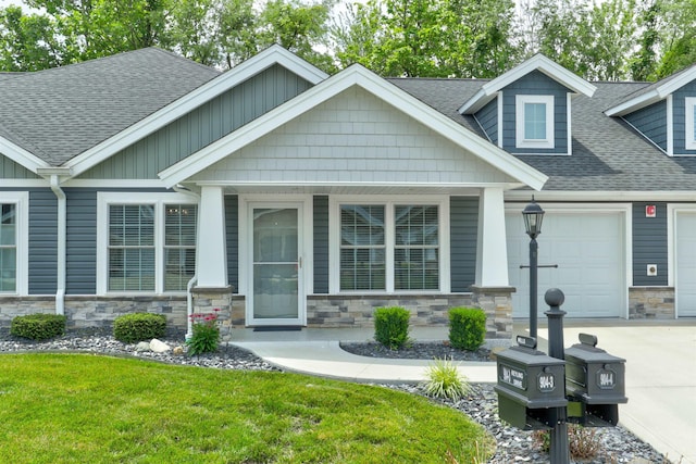 904-3 Reyling Dr, Jasper, IN 47546 - craftsman-style house featuring stone siding, roof with shingles, concrete driveway, and a garage