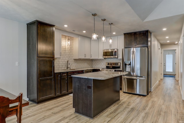 904-3 Reyling Dr, Jasper, IN 47546 - kitchen featuring appliances with stainless steel finishes, light wood-style floors, dark brown cabinetry, backsplash, and recessed lighting