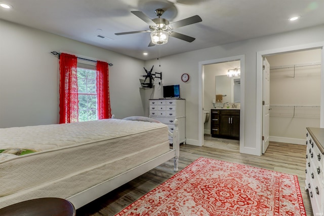 904-3 Reyling Dr, Jasper, IN 47546 - bedroom with recessed lighting, light wood-style flooring, a walk in closet, ensuite bath, and a ceiling fan
