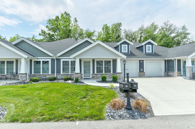 904-3 Reyling Dr, Jasper, IN 47546 - craftsman-style house with stone siding, a front lawn, a garage, driveway, and a shingled roof