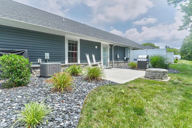 904-3 Reyling Dr, Jasper, IN 47546 - rear view of house featuring a patio area, roof with shingles, and stone siding