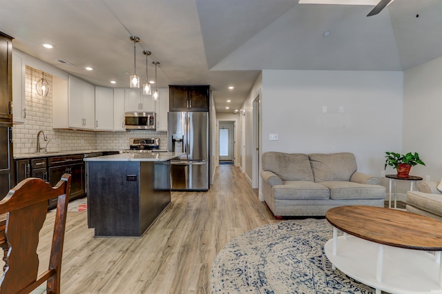 904-3 Reyling Dr, Jasper, IN 47546 - kitchen with appliances with stainless steel finishes, light wood-style flooring, a center island, light countertops, and ceiling fan