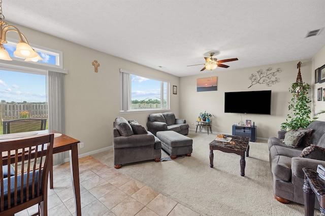 5590 Westfalen Way, Lafayette, IN 47905 - living area with ceiling fan, a textured ceiling, light carpet, and light tile patterned floors