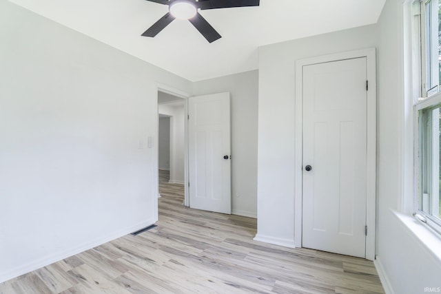 5729 Saint Joe Center Rd, Fort Wayne, IN 46835 - unfurnished bedroom featuring light wood finished floors, multiple windows, and ceiling fan