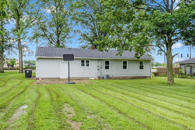 5729 Saint Joe Center Rd, Fort Wayne, IN 46835 - rear view of house with a lawn, a chimney, and roof with shingles