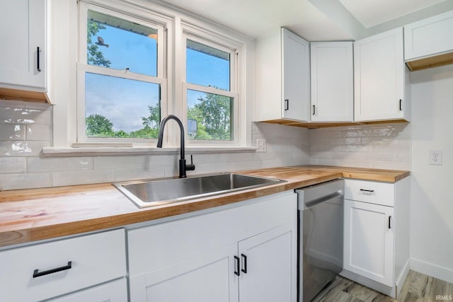 5729 Saint Joe Center Rd, Fort Wayne, IN 46835 - kitchen with butcher block countertops, dishwasher, white cabinetry, and backsplash