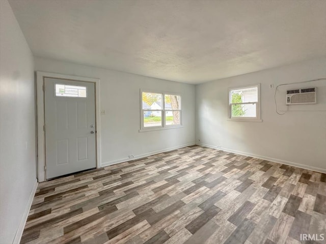 1032 E Dixon St, Kokomo, IN 46901 - foyer with a wall mounted air conditioner, wood finished floors, and plenty of natural light