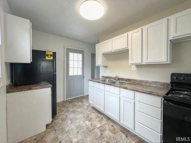 1032 E Dixon St, Kokomo, IN 46901 - kitchen featuring black appliances, a textured ceiling, white cabinets, and dark countertops