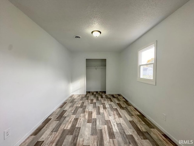 1032 E Dixon St, Kokomo, IN 46901 - unfurnished bedroom with a textured ceiling, wood finished floors, and a closet