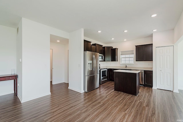 17951 Paula Walk, Westfield, IN 46074 - kitchen with appliances with stainless steel finishes, dark wood-style flooring, dark brown cabinets, light countertops, and a kitchen island