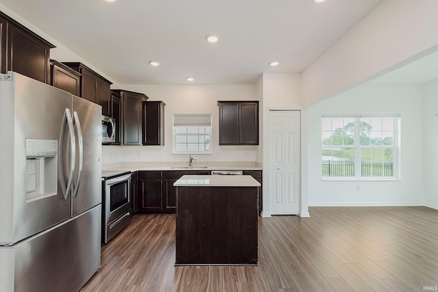 17951 Paula Walk, Westfield, IN 46074 - kitchen with stainless steel appliances, wood finished floors, a center island, dark brown cabinetry, and light countertops