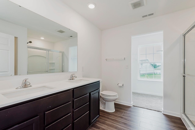 17951 Paula Walk, Westfield, IN 46074 - bathroom featuring a shower with door, double vanity, wood finished floors, and recessed lighting