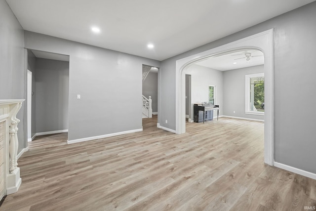 809 E 5th St, Fowler, IN 47944 - unfurnished living room with stairway, light wood finished floors, recessed lighting, and arched walkways