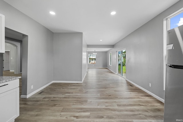 809 E 5th St, Fowler, IN 47944 - hall with healthy amount of natural light, light wood-style flooring, recessed lighting, and a chandelier